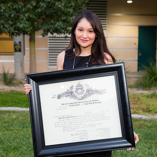 sorority woman posing with installation certificate